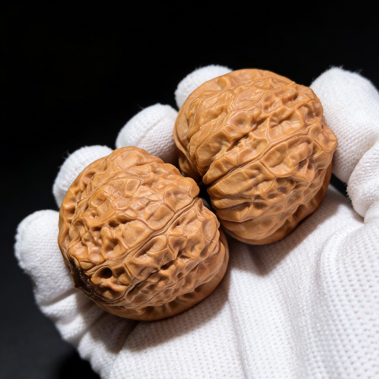 Pair of Walnut Hand Exercisers called Pumpkin Block (Nan Gua Dun) by ThePatinaProject, measuring 42mm x 44mm, with carved pumpkin design.
