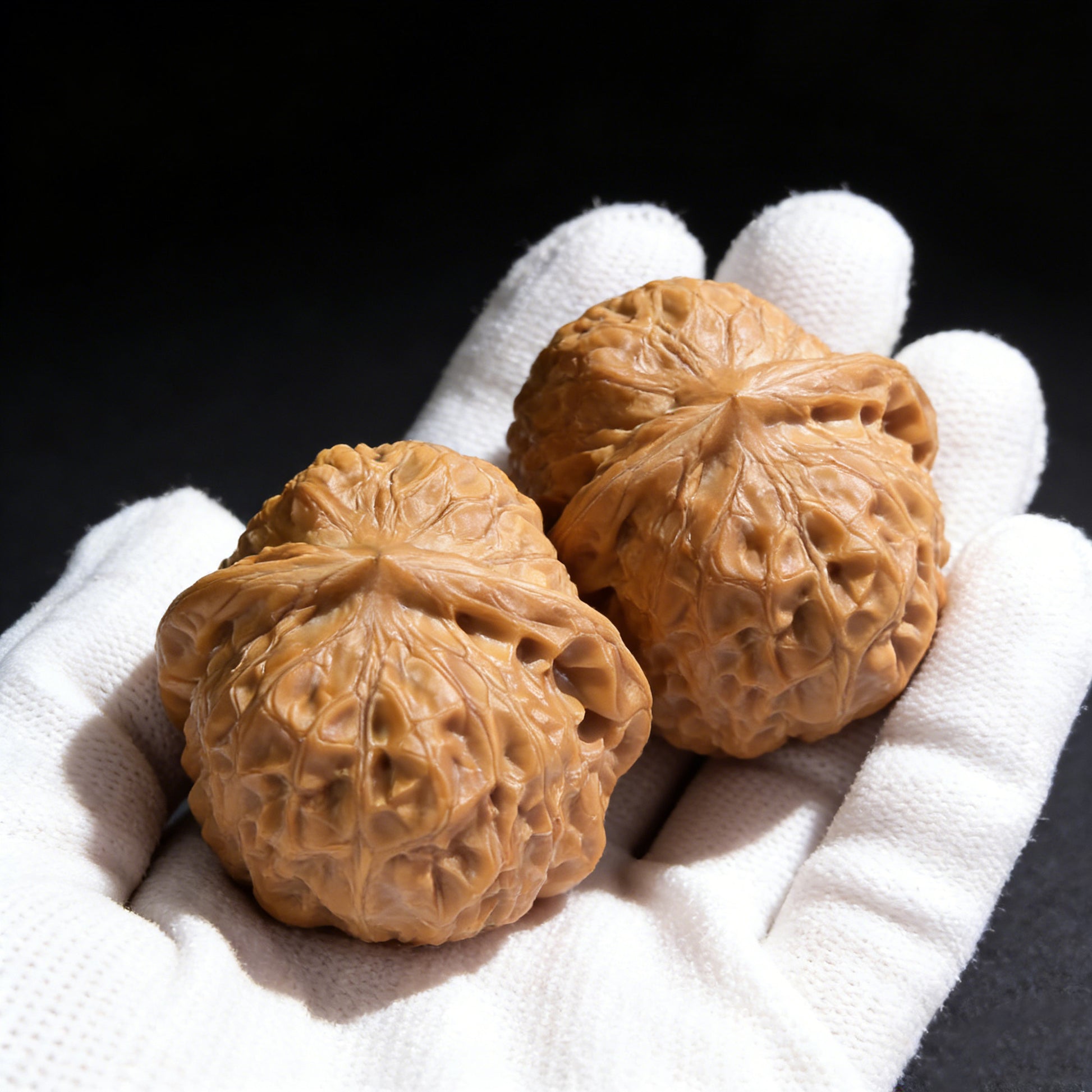 Walnut hand exerciser "Pumpkin Block" pair from ThePatinaProject, 42mm x 44mm, featuring textured pumpkin design for grip and strength training.