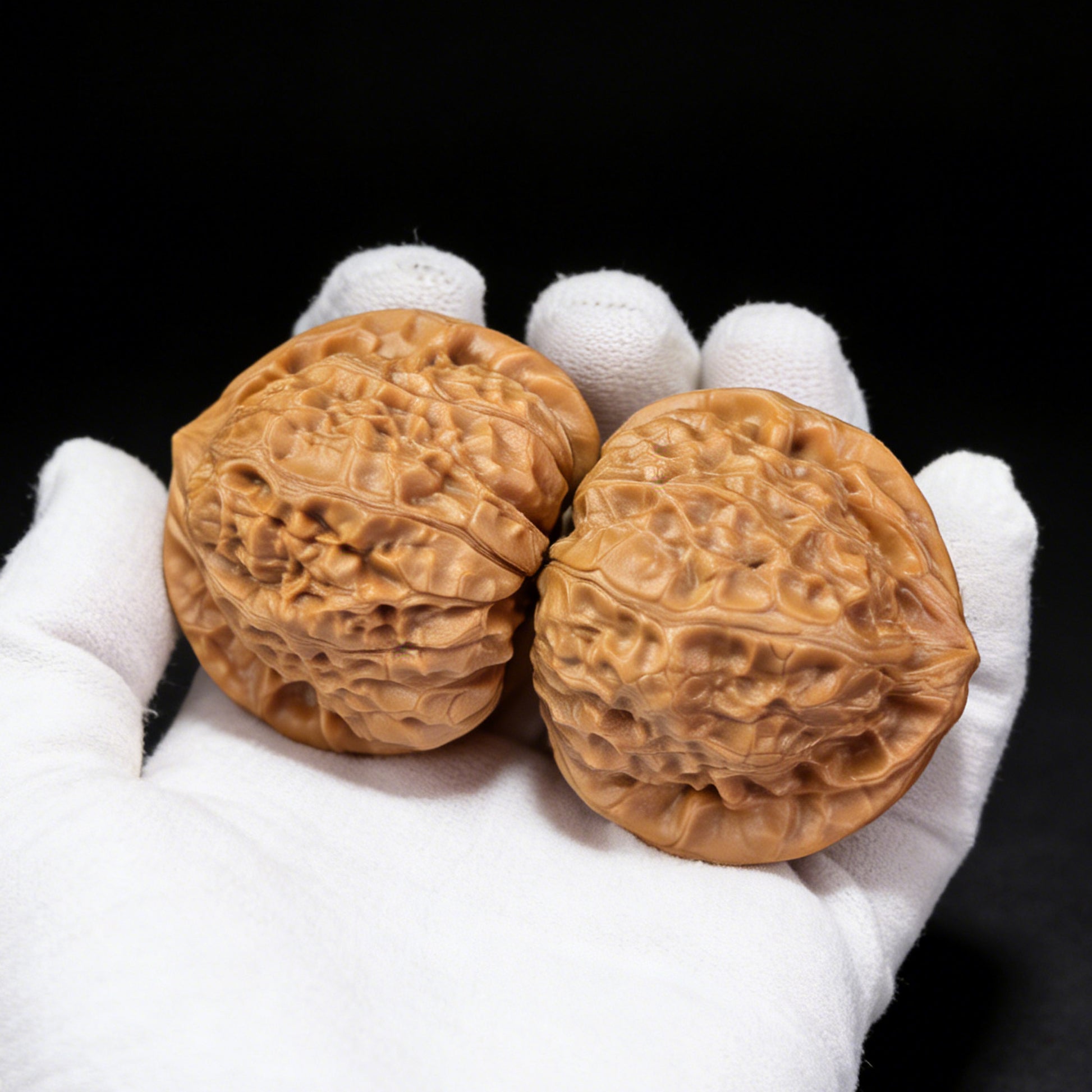 Pair of Walnut Hand Exercisers called Pumpkin Block from ThePatinaProject, measuring 45mm by 40mm, with textured pumpkin shape.