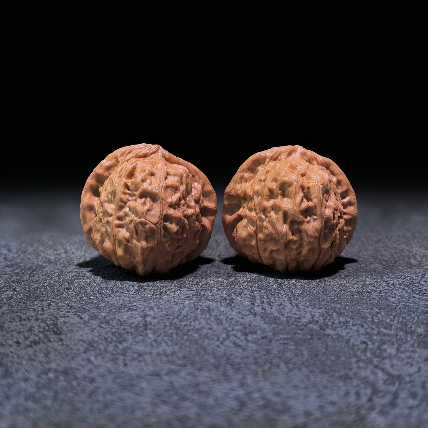 Walnut hand exerciser pair "Pumpkin Squat" by ThePatinaProject, 42mm x 42mm, showing textured walnut surface for grip and exercise.