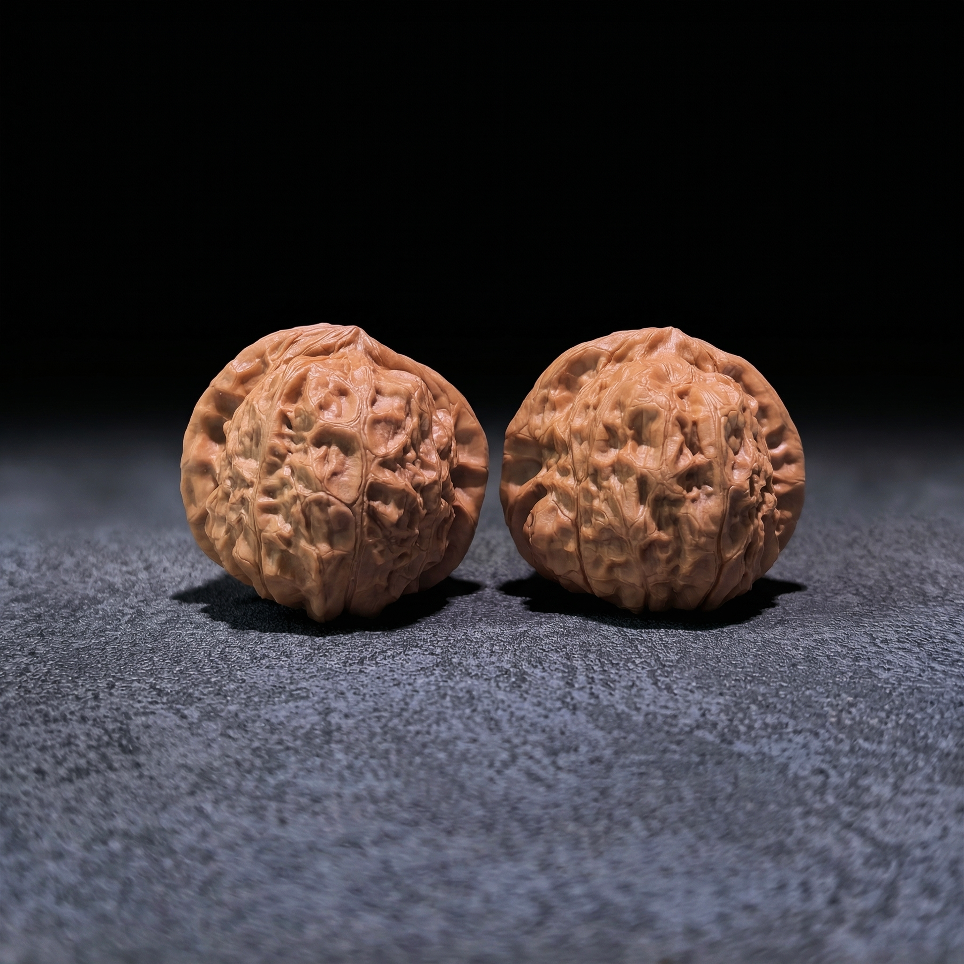Walnut hand exerciser pair "Pumpkin Squat" by ThePatinaProject, 42mm x 42mm, showing textured walnut surface for grip and exercise.