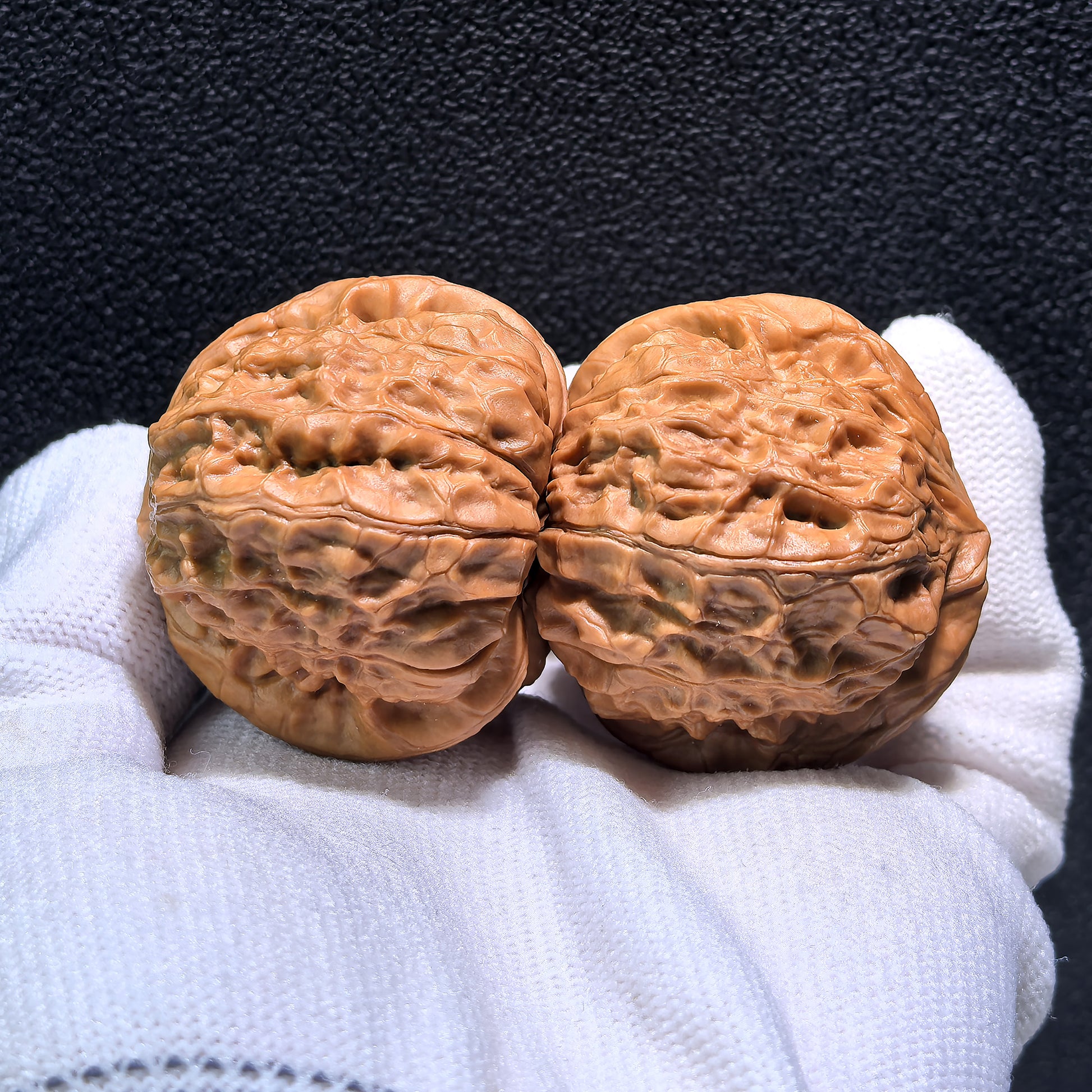 Pair of Walnut Hand Exercisers labeled Pumpkin Squat, 42mm x 42mm, from ThePatinaProject, with textured walnut surface for grip.