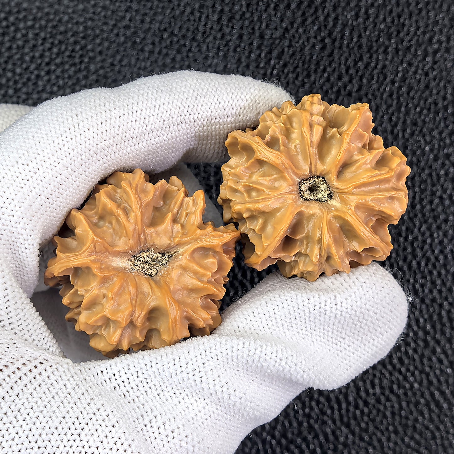 Pair of ThePatinaProject Qi San Four-Ridge walnut hand exercisers, 34mm x 33mm, with textured ridges for grip and hand strengthening.