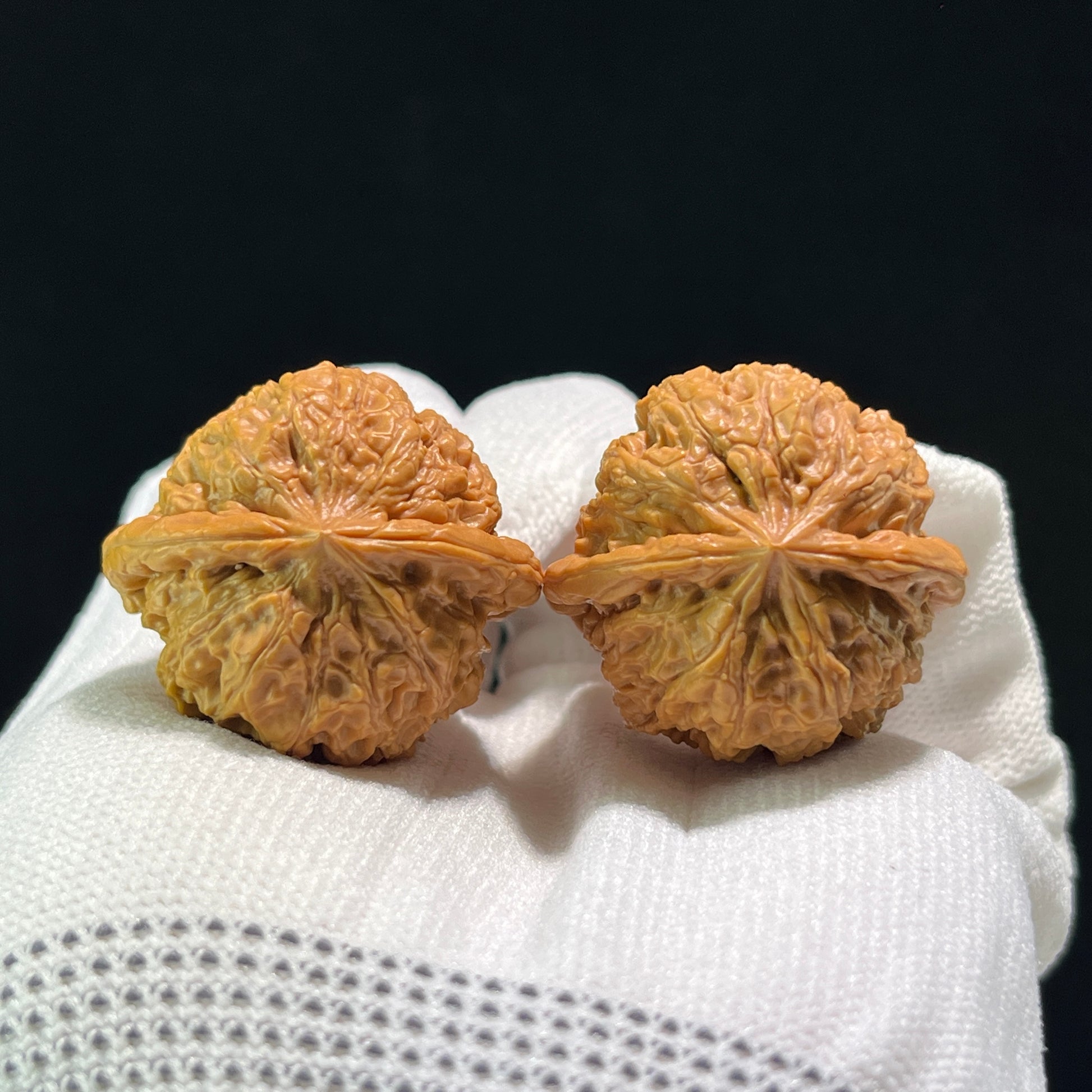 Walnut hand exerciser pair labeled YHS-601 with rain flower pebble design, measuring 34mm by 31mm, from ThePatinaProject.