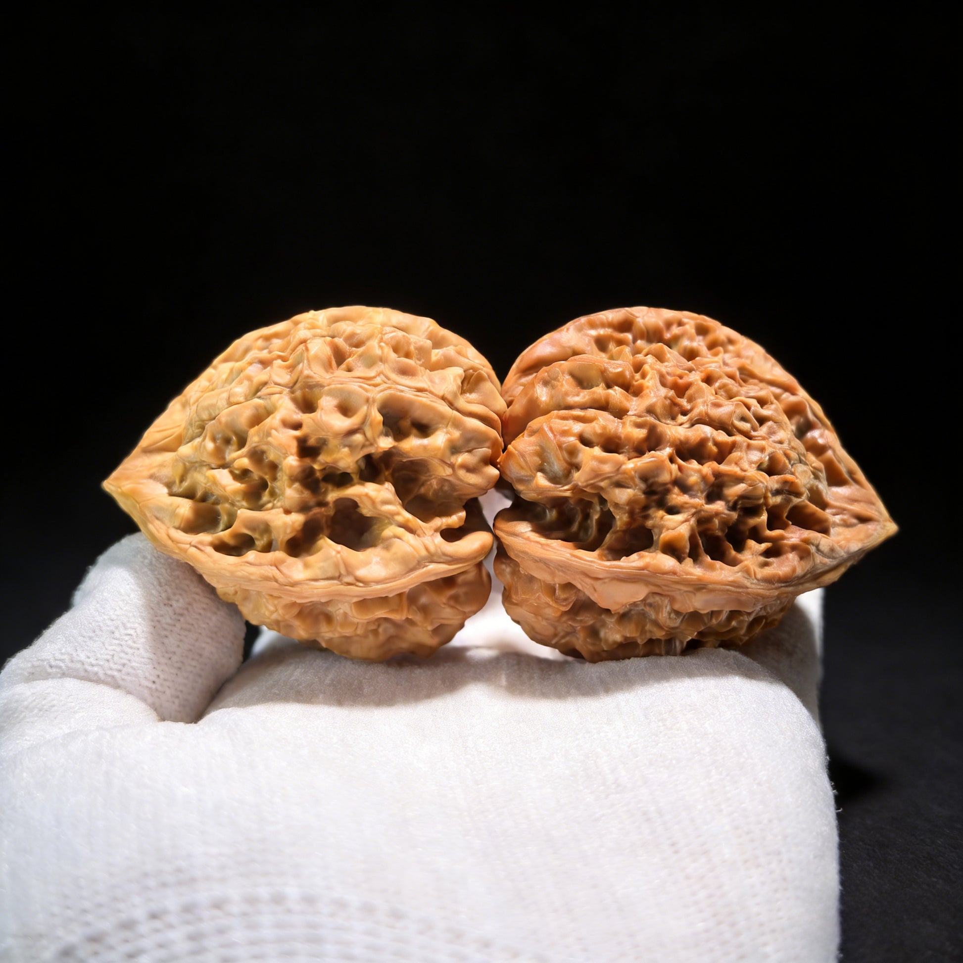 Walnut hand exercisers from ThePatinaProject, triangle-shaped collector's pair with 38mm and 49mm dimensions, DGMSN-02E model.