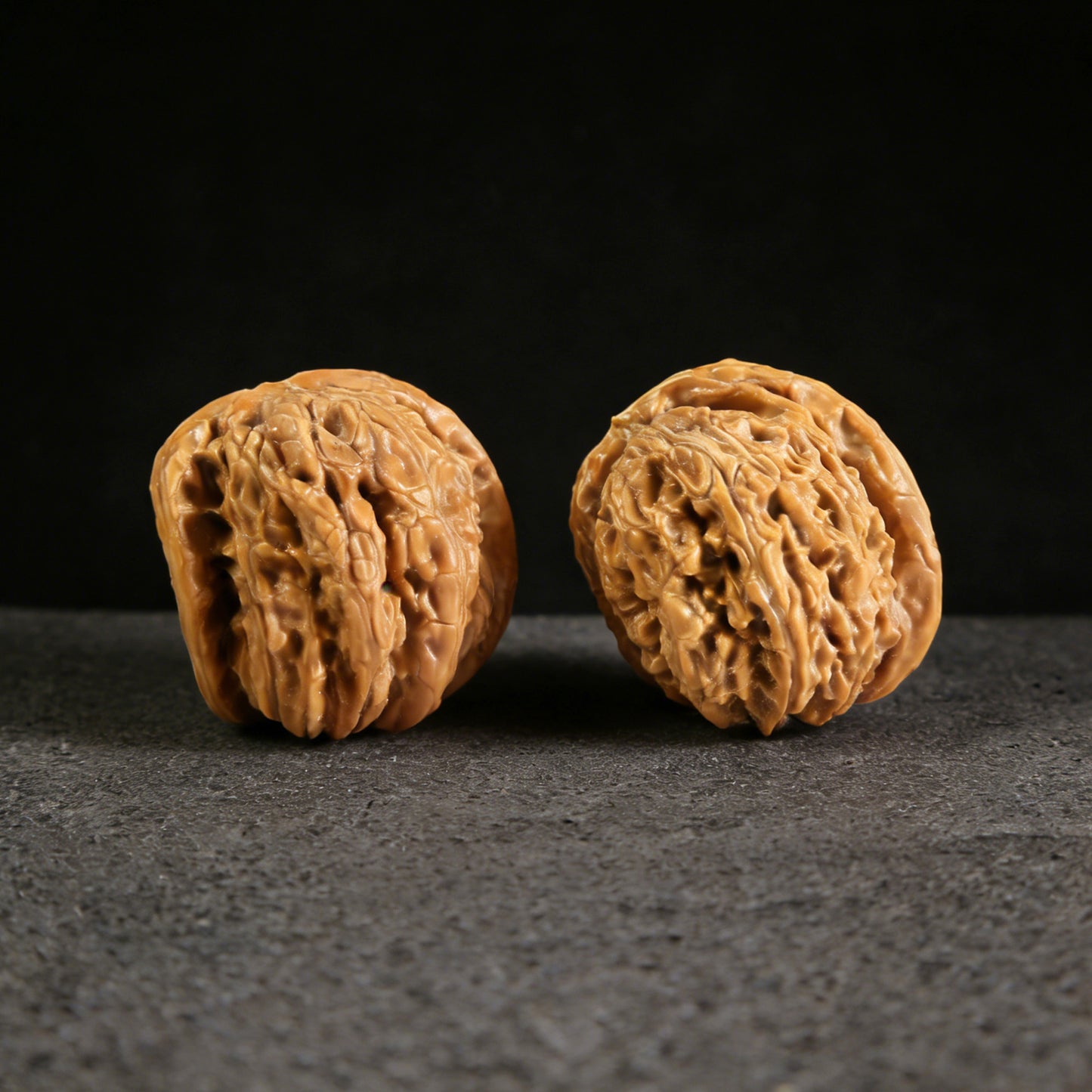 Pair of Walnut Hand Exercisers featuring white lion head designs from ThePatinaProject, measuring 32mm, called "Twin-Husk" White Lion Head.