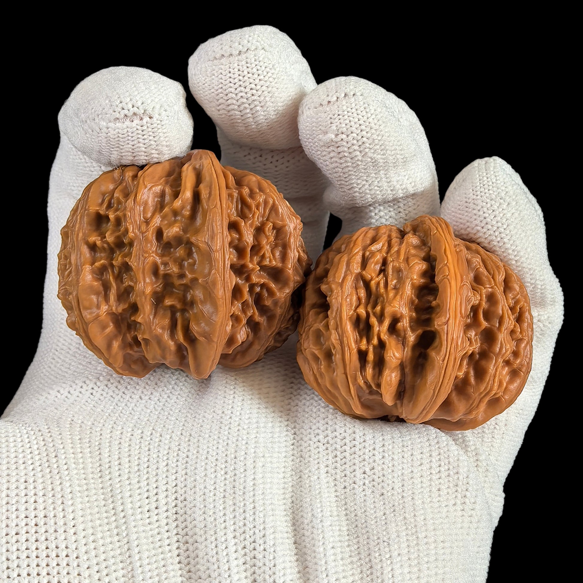 Pair of white lion head walnut hand exercisers from ThePatinaProject, 39mm Twin-Husk "Banbi" model, featuring detailed lion head designs.