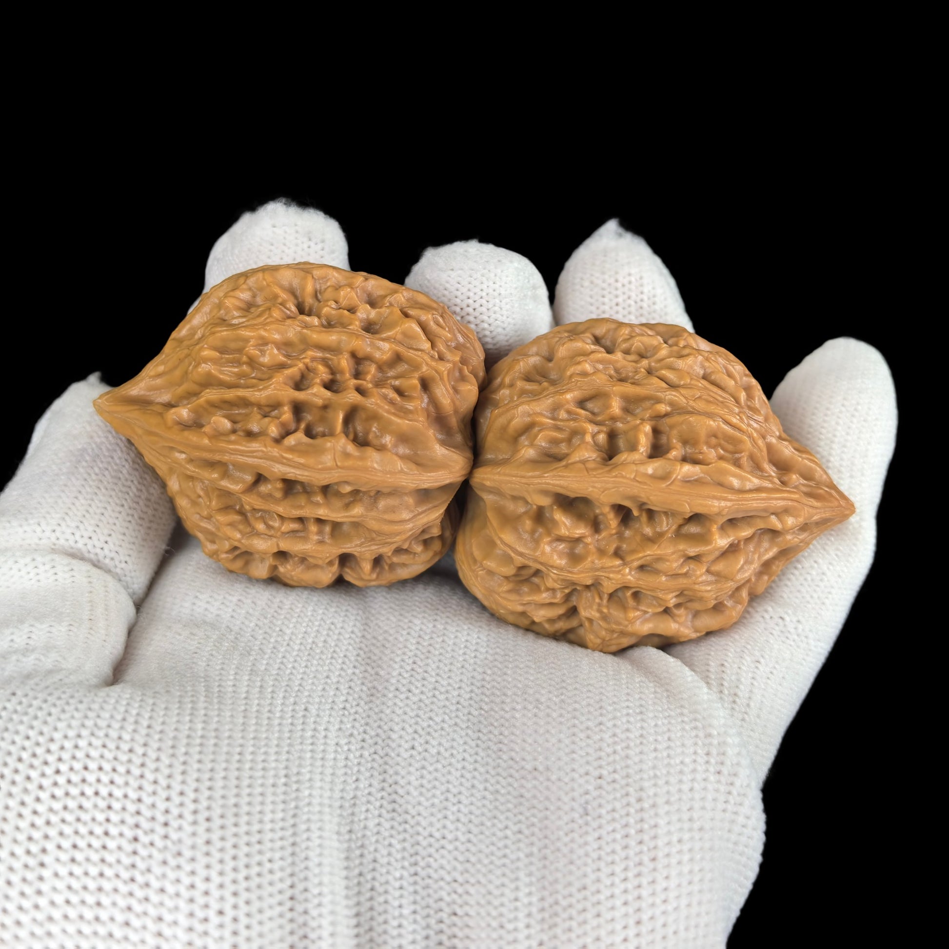 Walnut hand exercisers from ThePatinaProject's "Seven Mountains" pair, 35mm, QS-01, showing textured walnut surface and ergonomic design.