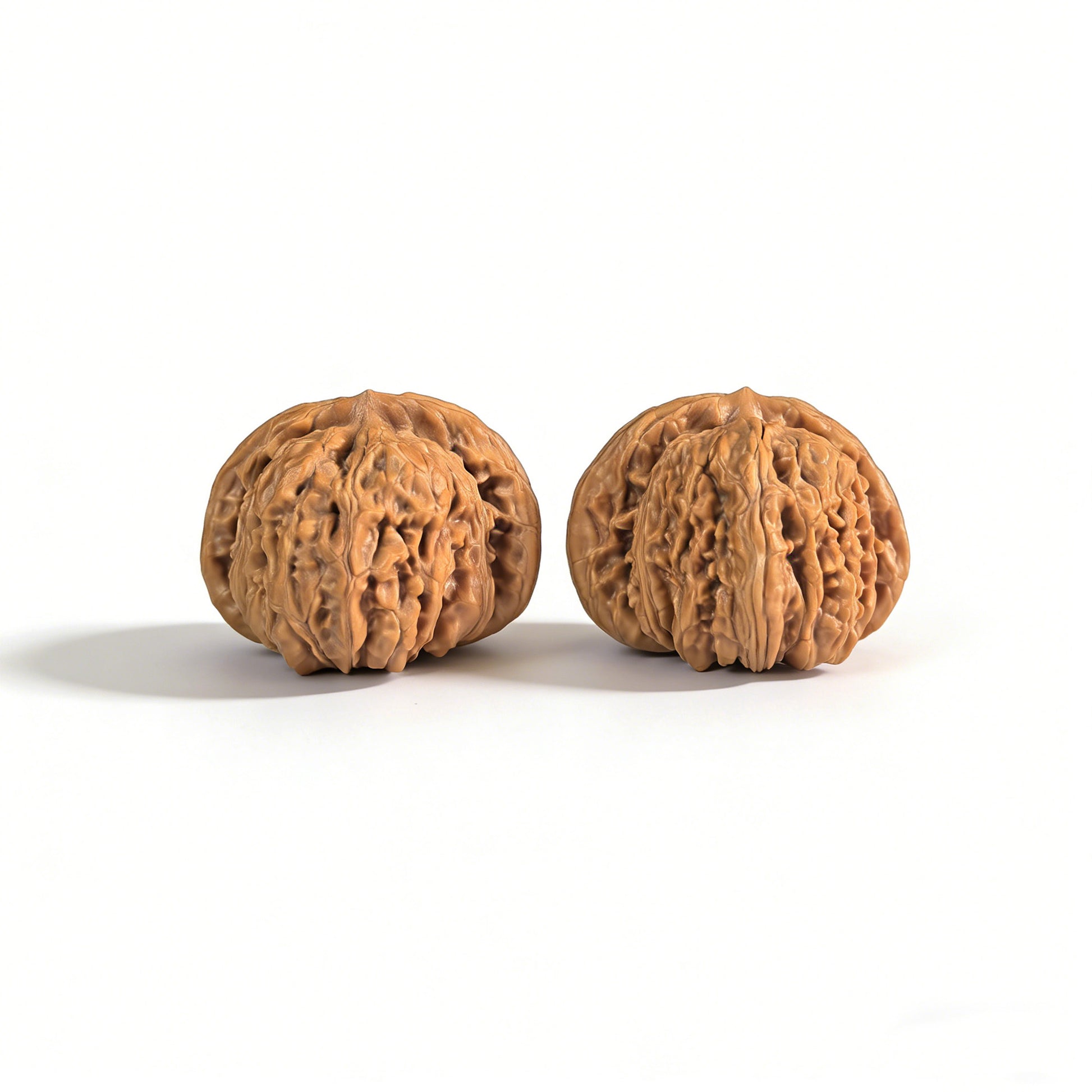 Pair of walnut lion head hand exercisers from ThePatinaProject, 43mm x 40mm, with detailed carved lion head designs.