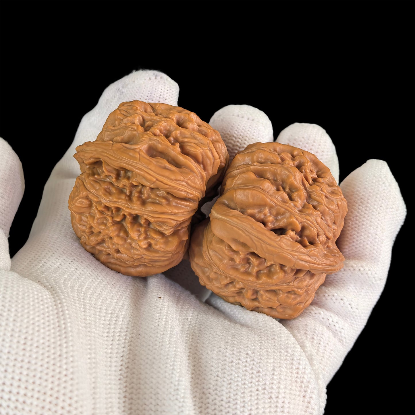 Pair of walnut lion head hand exercisers from ThePatinaProject, 43mm by 40mm, with detailed carved lion face designs.