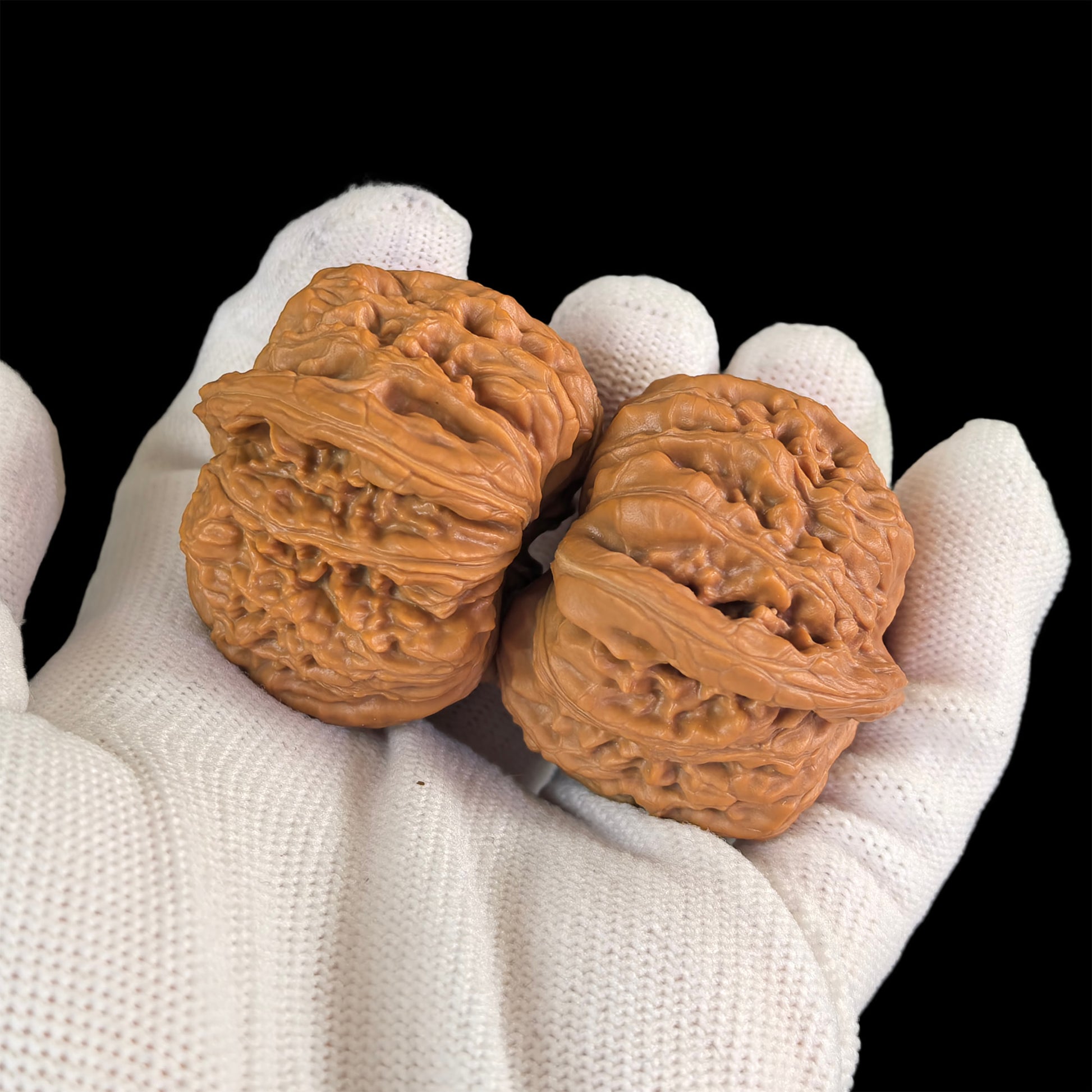 Pair of walnut lion head hand exercisers from ThePatinaProject, 43mm by 40mm, with detailed carved lion face designs.