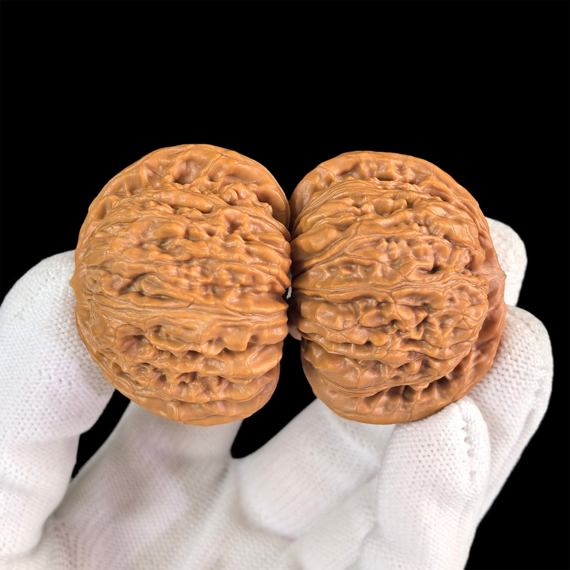 Pair of walnut lion head hand exercisers from ThePatinaProject, 43mm x 40mm, featuring detailed carved lion face designs.