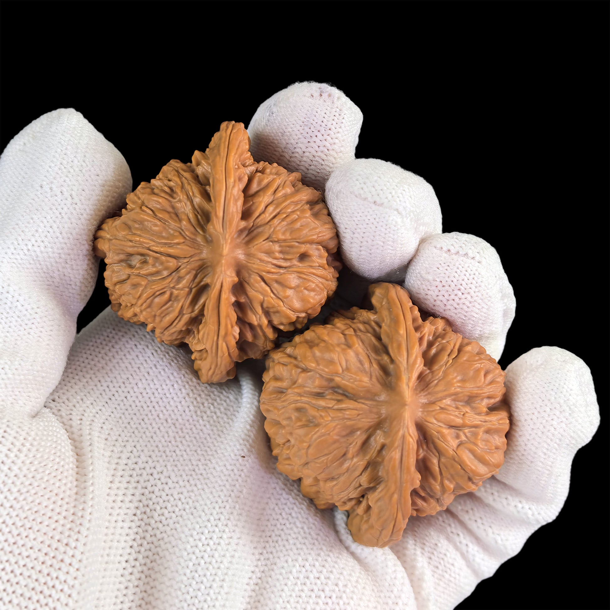 Pair of walnut lion head hand exercisers from ThePatinaProject, 43mm by 40mm, showcasing detailed carved lion head designs.