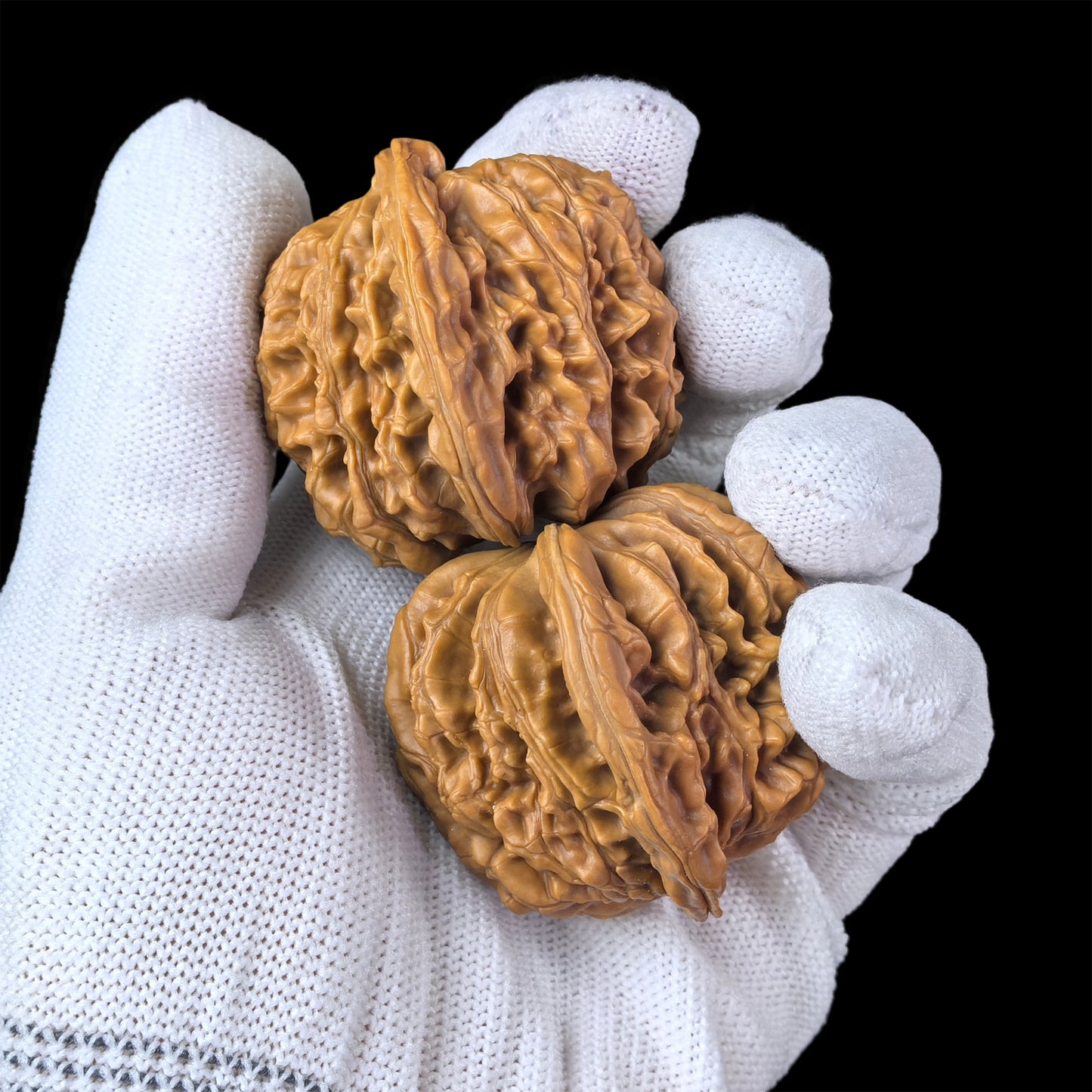 Pair of walnut hand exercisers with lion head detail, 45mm x 42mm, by ThePatinaProject, showcasing textured wooden grips and lion design.