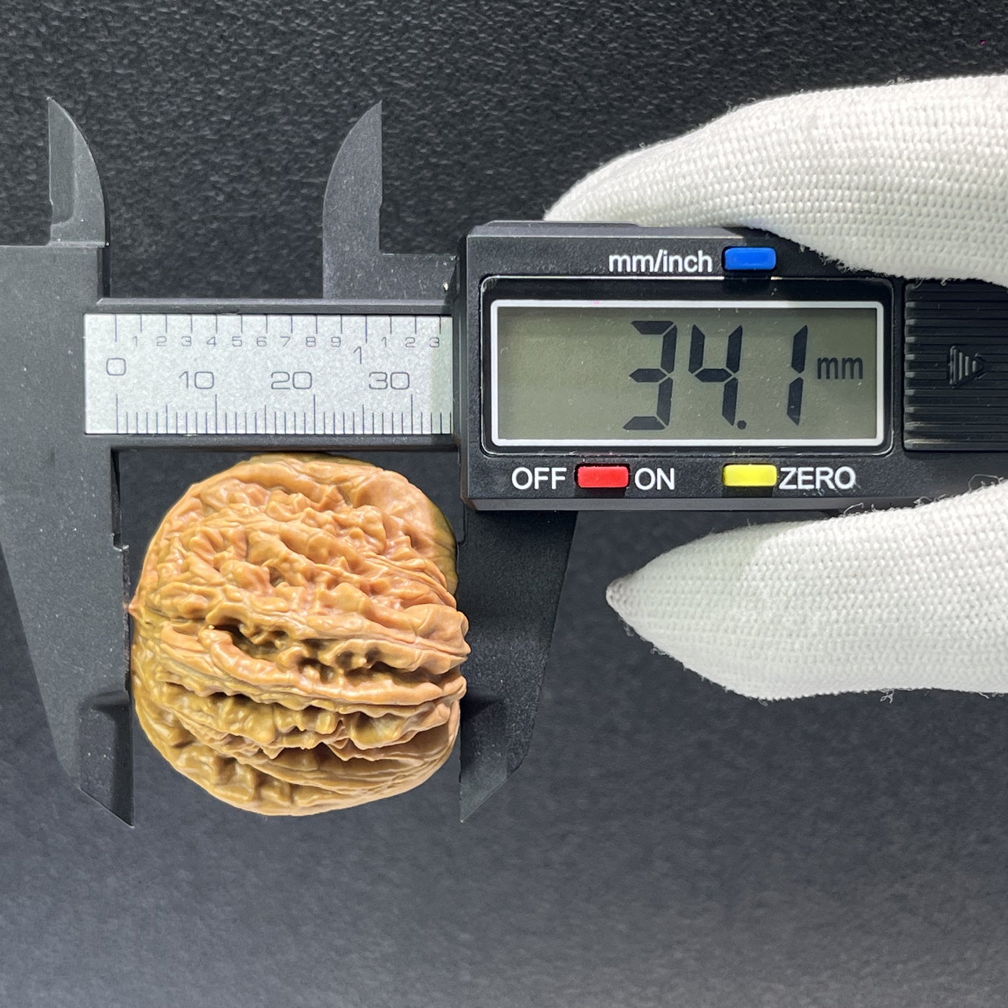 Pair of walnut lion's head hand exercisers from ThePatinaProject, 38mm size, showcasing detailed carved lion's head design.
