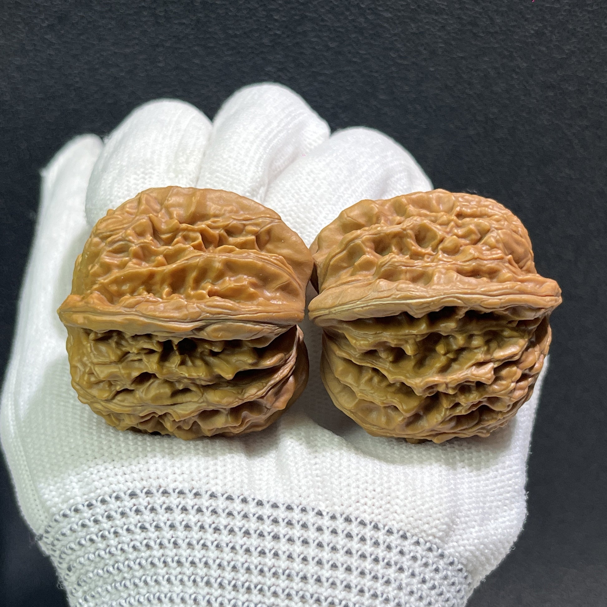 Pair of walnut hand exercisers with lion's head design, 40mm x 39mm, from ThePatinaProject's Si Zuo Lou collection.