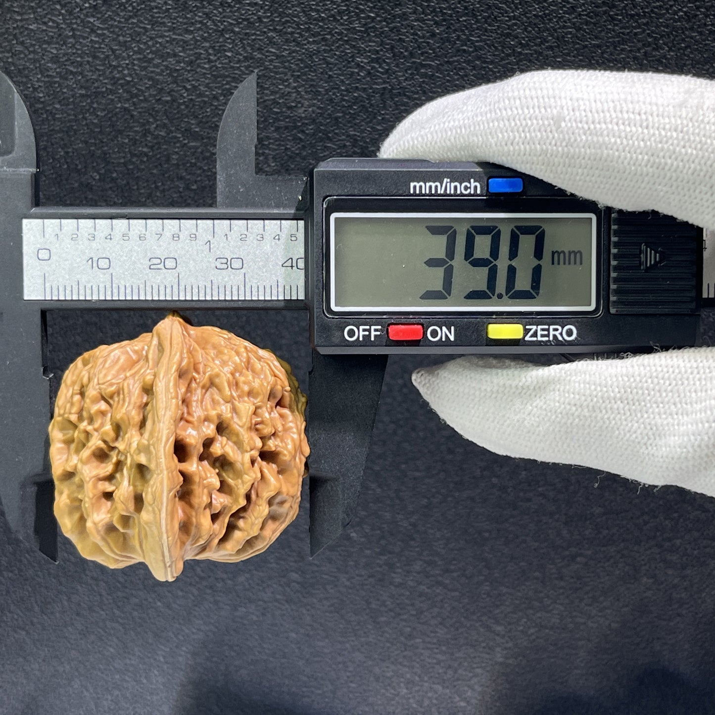 Pair of walnut lion's head hand exercisers from ThePatinaProject, 40mm x 39mm, featuring detailed carved lion head designs.