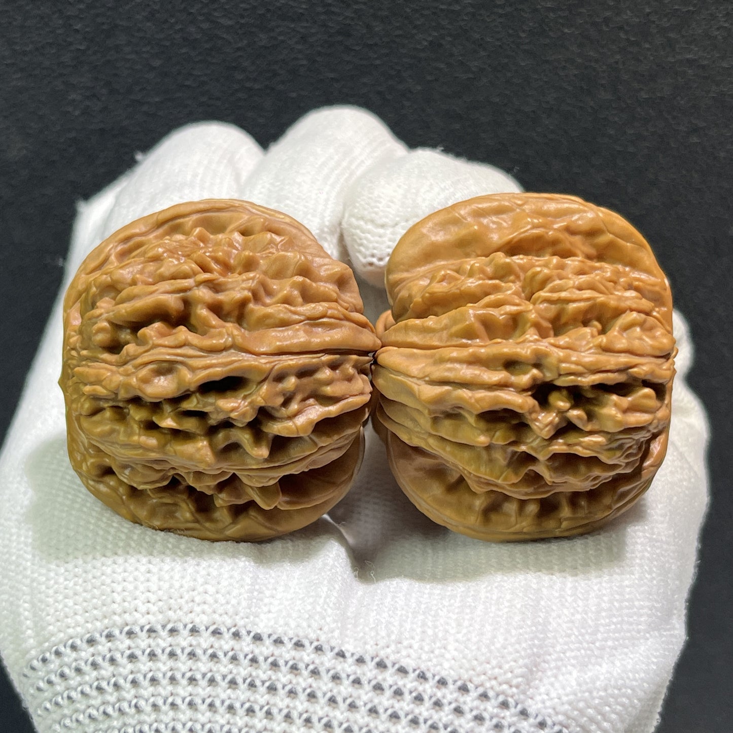 Pair of ThePatinaProject Si Zuo Lou Walnut Lion's Head hand exercisers, 40mm x 42mm, with detailed carved lion head designs.