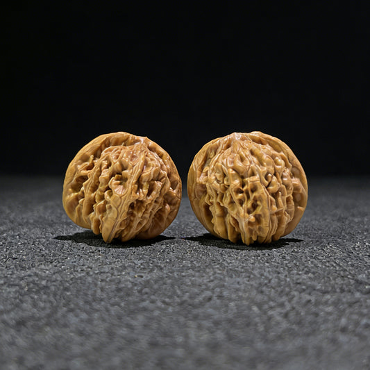 Pair of walnut hand exercisers featuring lion's head design, 41mm size from ThePatinaProject's Si Zuo Lou collection.