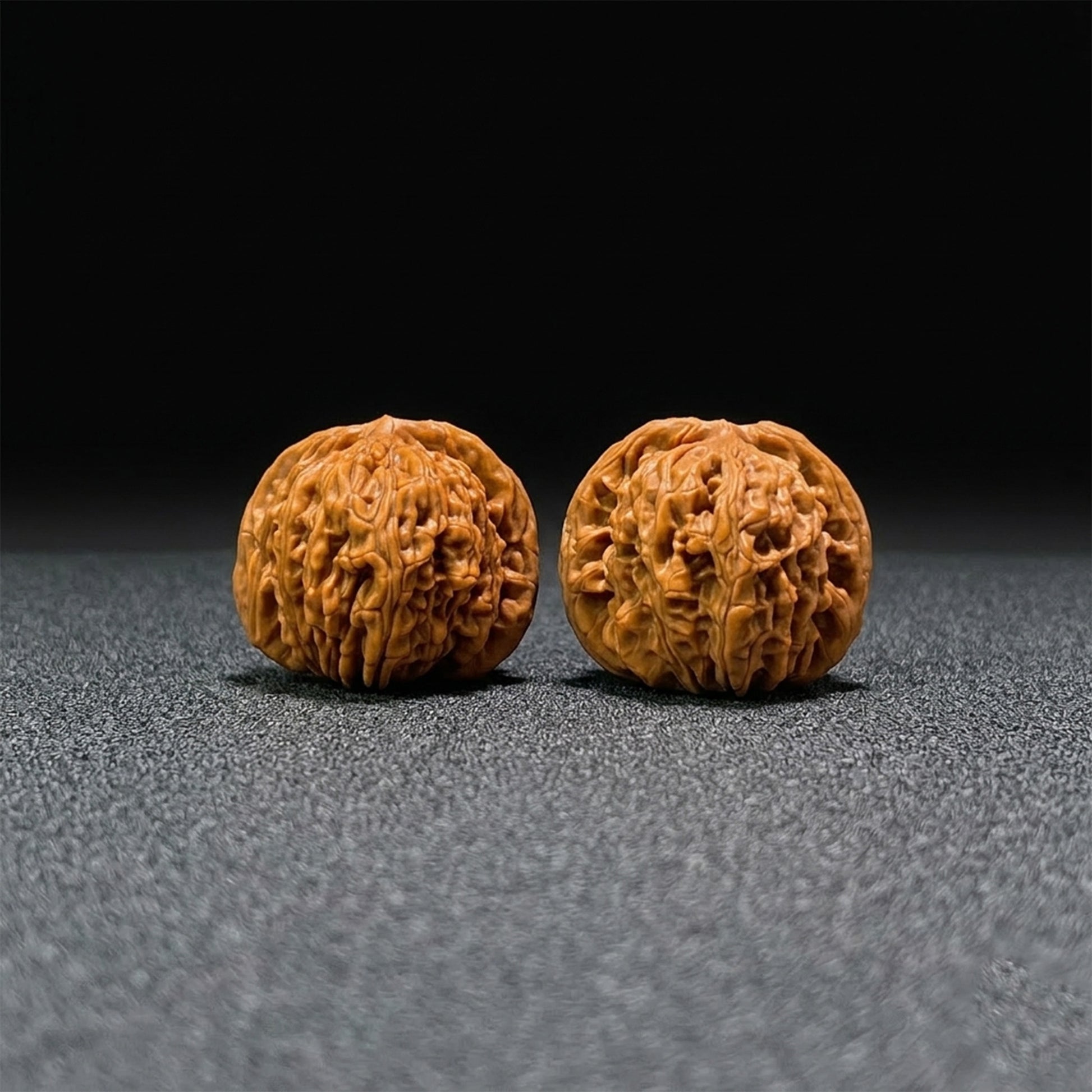 Pair of Walnut Lion's Head hand exercisers from ThePatinaProject, 42mm by 41mm, featuring detailed carved lion head designs.
