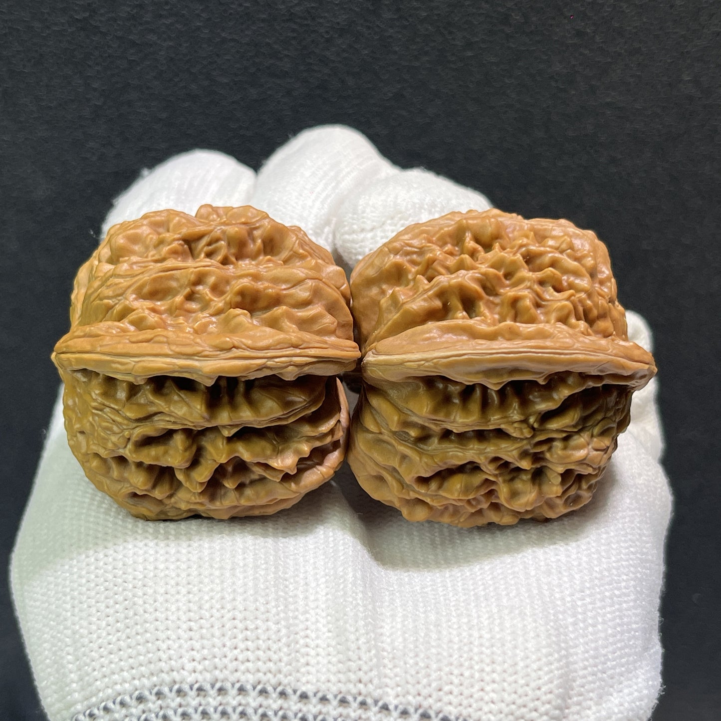 Pair of Walnut Lion's Head hand exercisers from ThePatinaProject, 43mm x 40mm, featuring detailed carved lion heads.