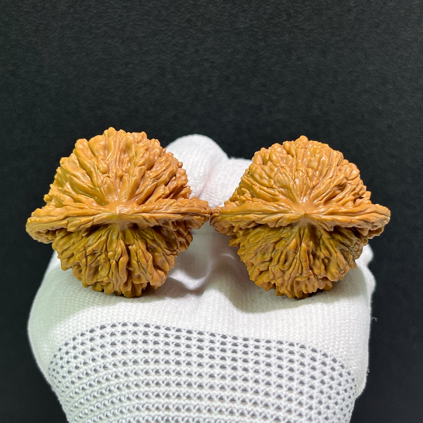 Pair of Walnut hand exercisers from ThePatinaProject, lion's head design, 43mm by 40mm, SZL-514, showcasing detailed craftsmanship.