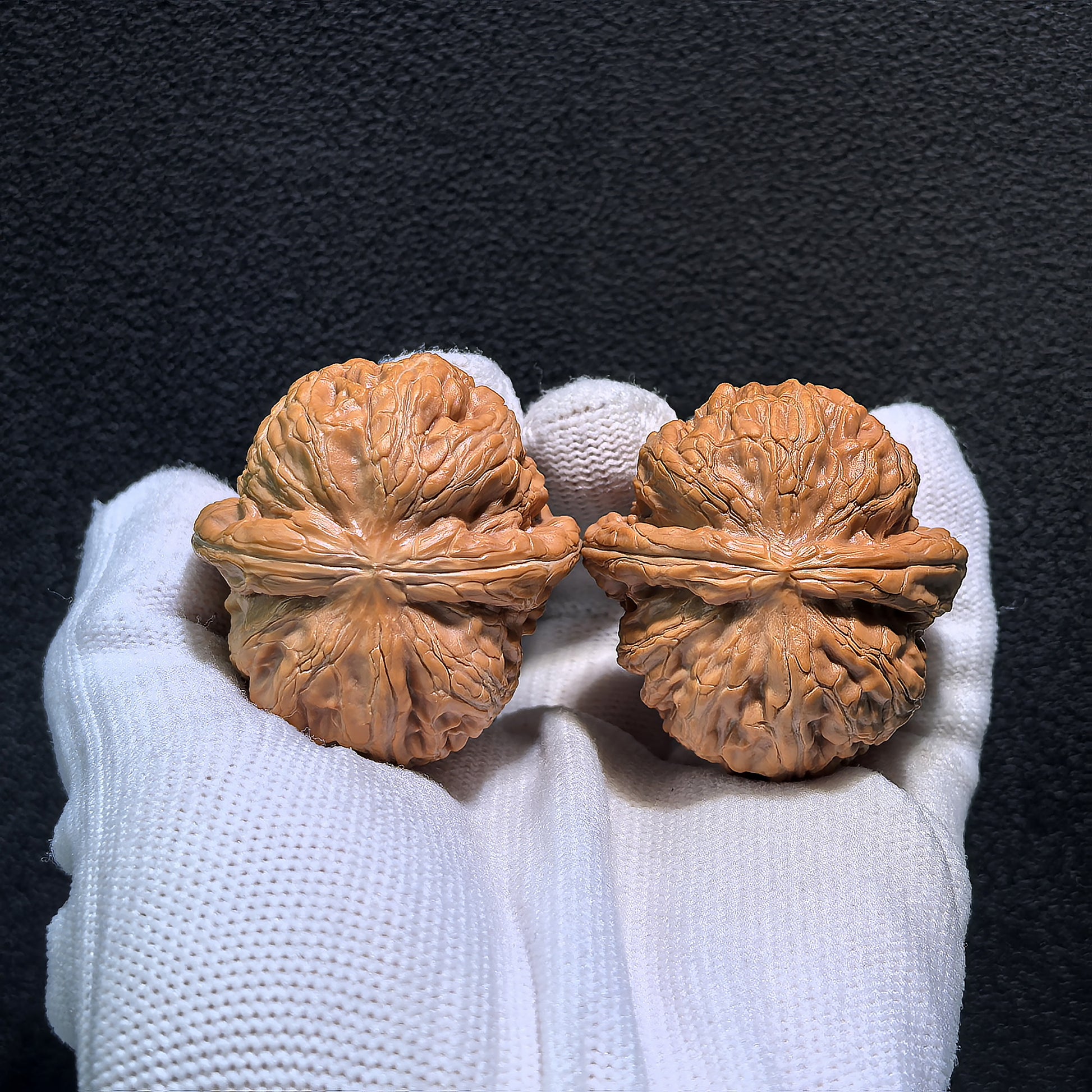 Walnut hand exerciser pair "Thick Ridge" by ThePatinaProject, 40mm x 41mm, showing textured wooden grips for grip strength training.