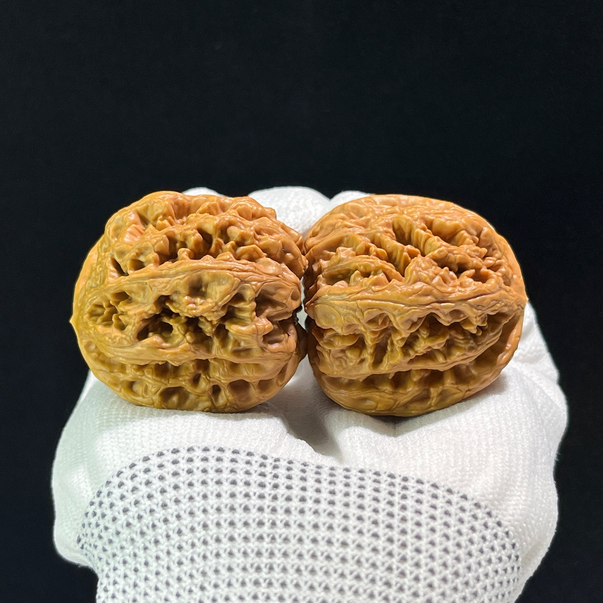 Pair of Walnut hand exercisers called Thick Ridge Lion's Head by ThePatinaProject, featuring detailed carved lion head designs.