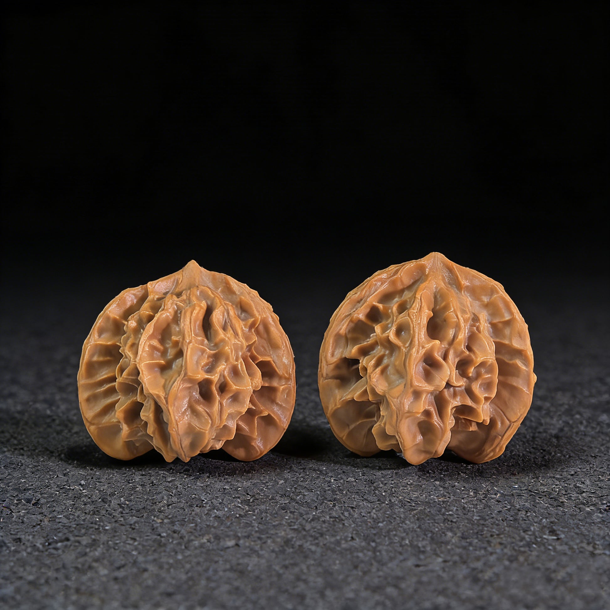 Pair of Walnut Hand Exercisers called Three-Ridge Ben with 33mm x 32mm size from ThePatinaProject, featuring textured ridges for grip.