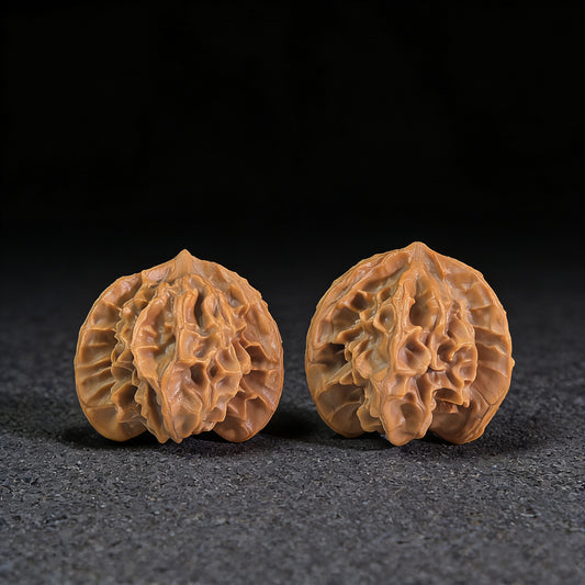 Pair of Walnut Hand Exercisers called Three-Ridge Ben with 33mm x 32mm size from ThePatinaProject, featuring textured ridges for grip.