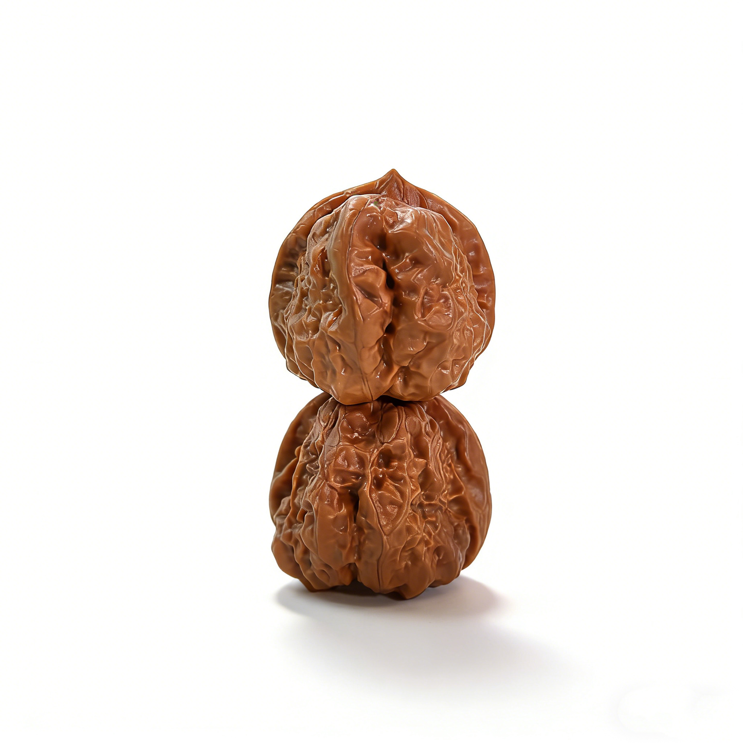 Pair of walnut "Toad Head" low-profile Zen architecture hand exercisers from ThePatinaProject, showing the detailed carved design.