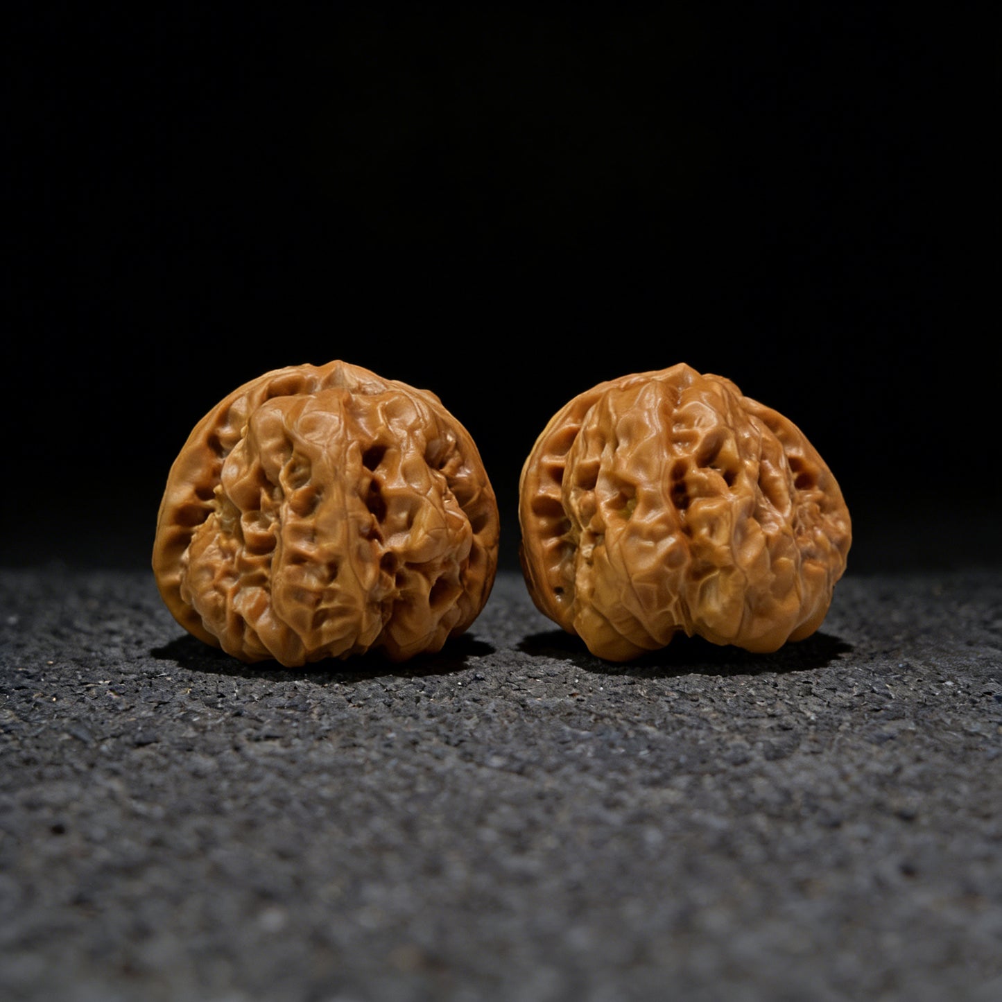 Pair of walnut hand exercisers labeled HMT-405 with 36.0mm x 39.0mm dimensions, designed for hand strengthening.