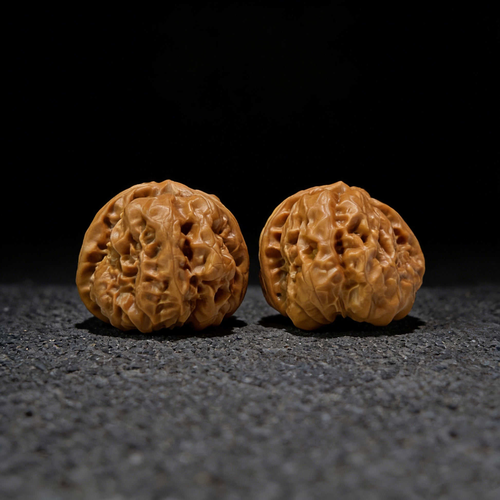 Pair of walnut hand exercisers labeled HMT-405 with 36.0mm x 39.0mm dimensions, designed for hand strengthening.