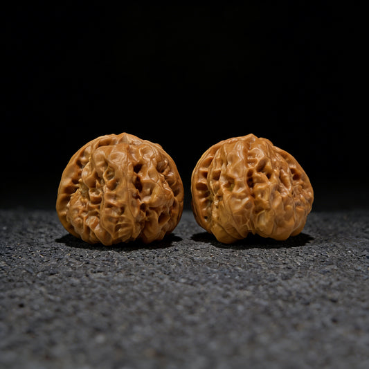 Pair of walnut hand exercisers labeled HMT-405 with 36.0mm x 39.0mm dimensions, designed for hand strengthening.