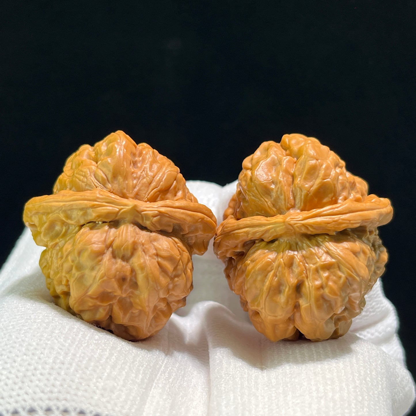 Pair of walnut hand exercisers called Toad Head (Ha Ma Tou) by ThePatinaProject, measuring 36mm x 40mm, W-602 model.