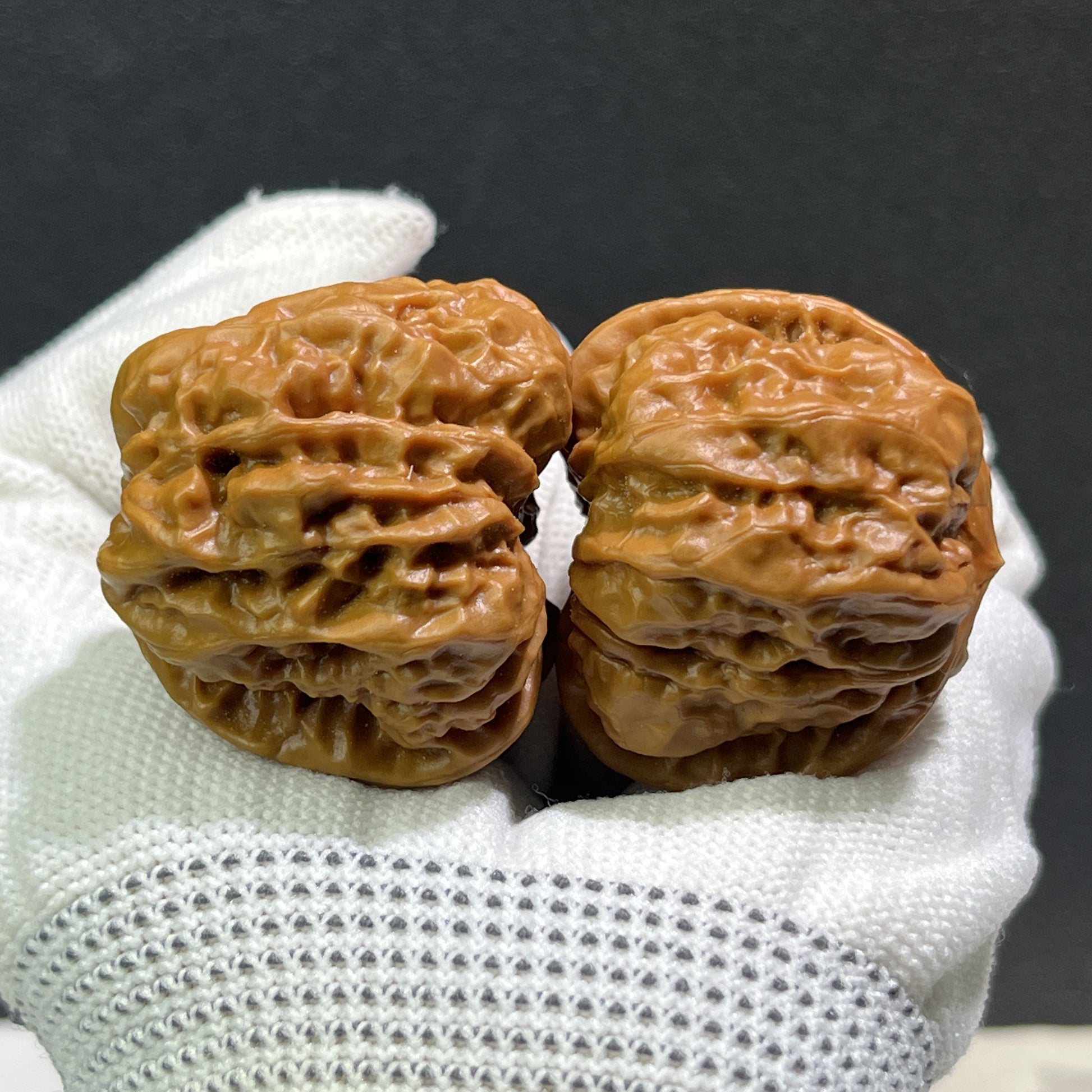 Pair of walnut hand exercisers labeled "Toad Head" by ThePatinaProject, measuring 37mm x 39mm, HMT-406, with carved textured surfaces.