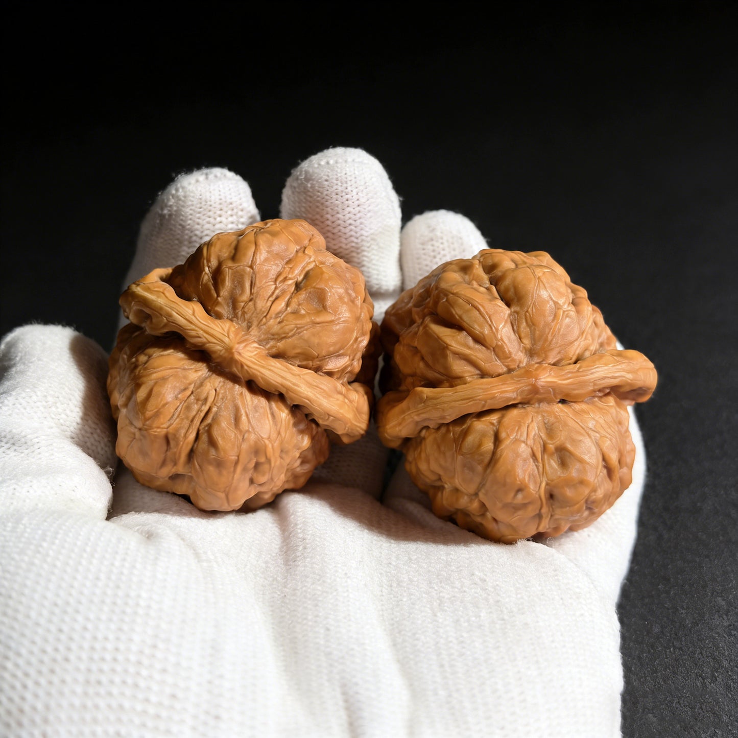 Pair of walnut hand exercisers with "Toad Head" design, collector grade, by ThePatinaProject, measuring 43mm x 42mm.