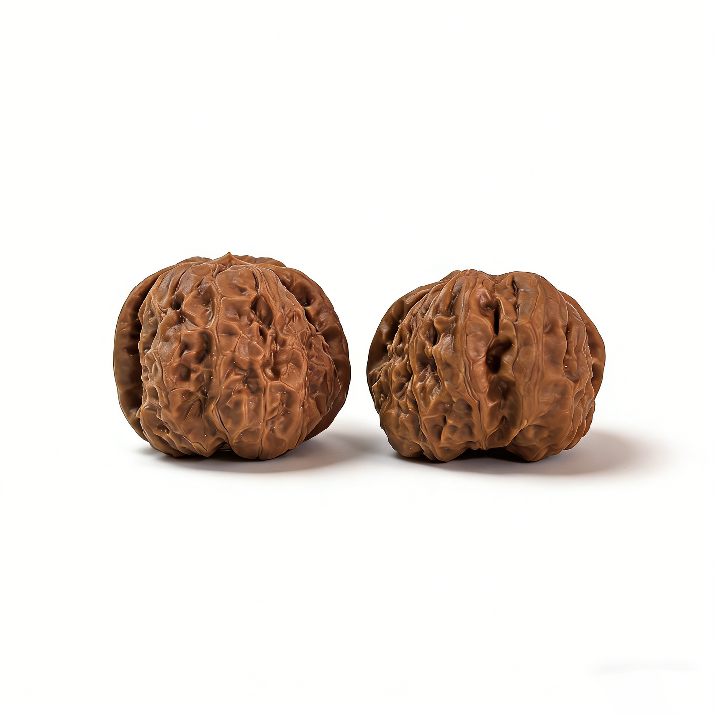 Pair of walnut hand exercisers with rugged ancient texture and flat-base silhouette, 39mm size from ThePatinaProject.
