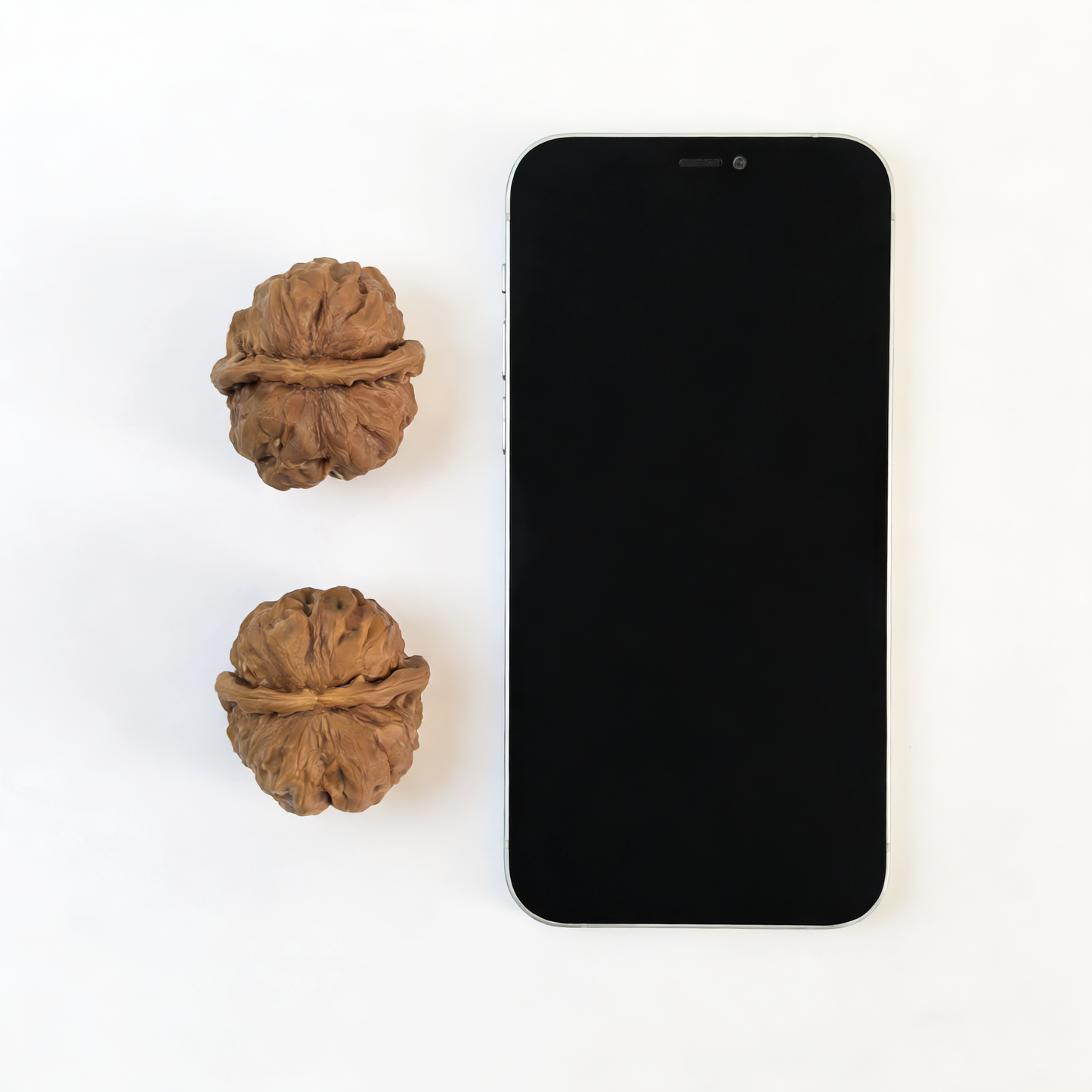 Pair of walnut hand exercisers with rugged ancient texture and flat-base silhouette, 39mm size by ThePatinaProject.