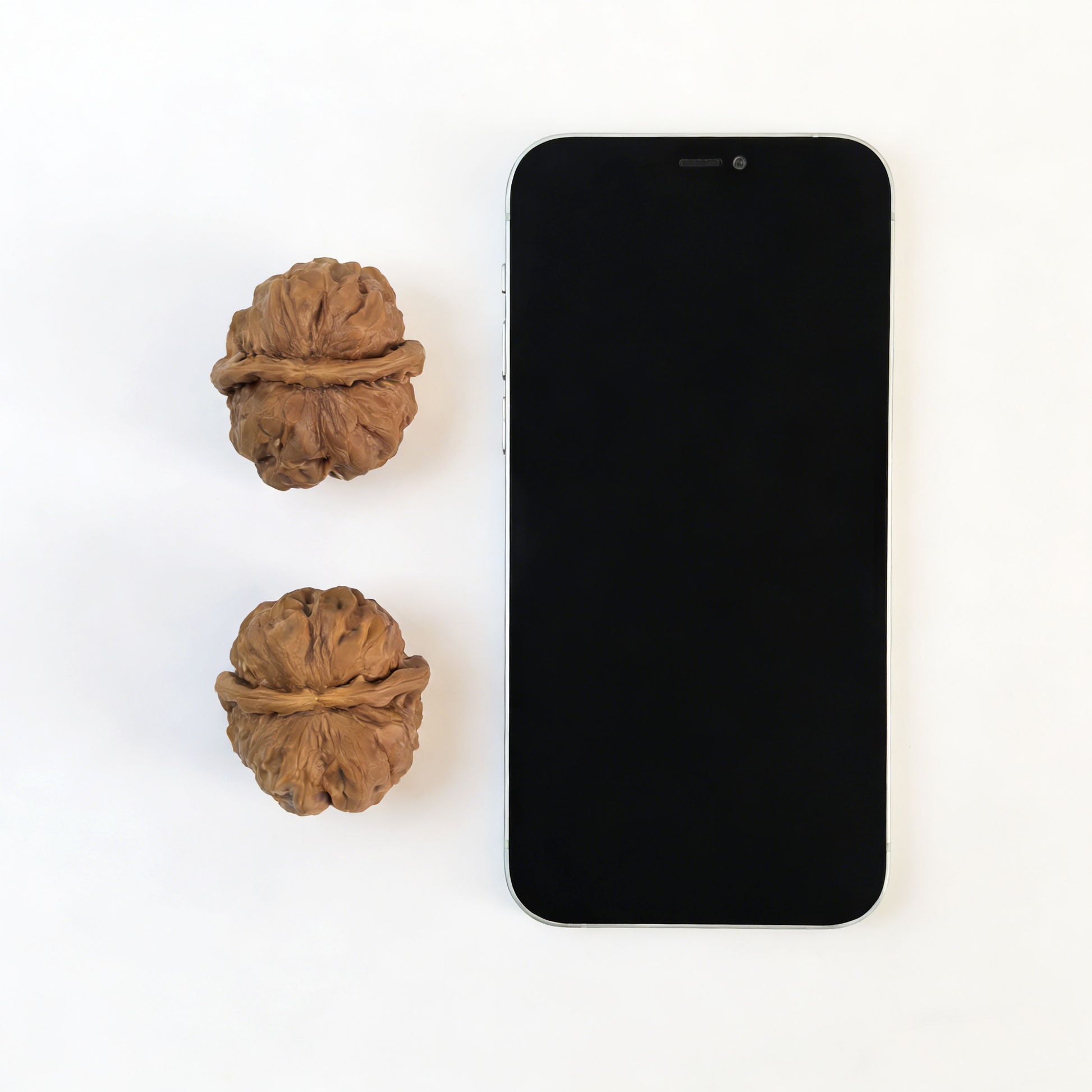 Pair of walnut hand exercisers with rugged ancient texture and flat-base silhouette, 39mm size by ThePatinaProject.