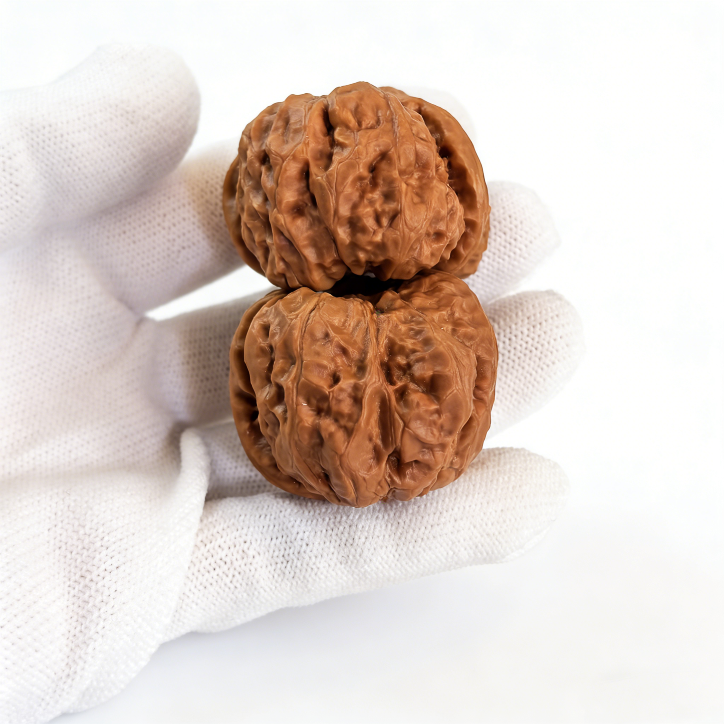 Pair of walnut hand exercisers featuring rugged ancient texture and flat-base silhouette, 39mm size by ThePatinaProject.