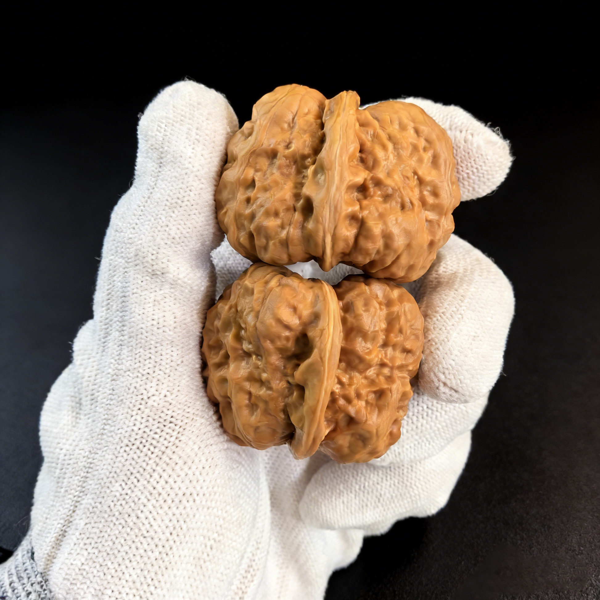 Pair of walnut hand exercisers titled "Toad Head" with textured skin, featuring 35mm architecture by ThePatinaProject.