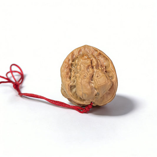 Walnut hand exerciser pendant featuring natural sculptural toad head design, handcrafted by ThePatinaProject, 32mm accessory.