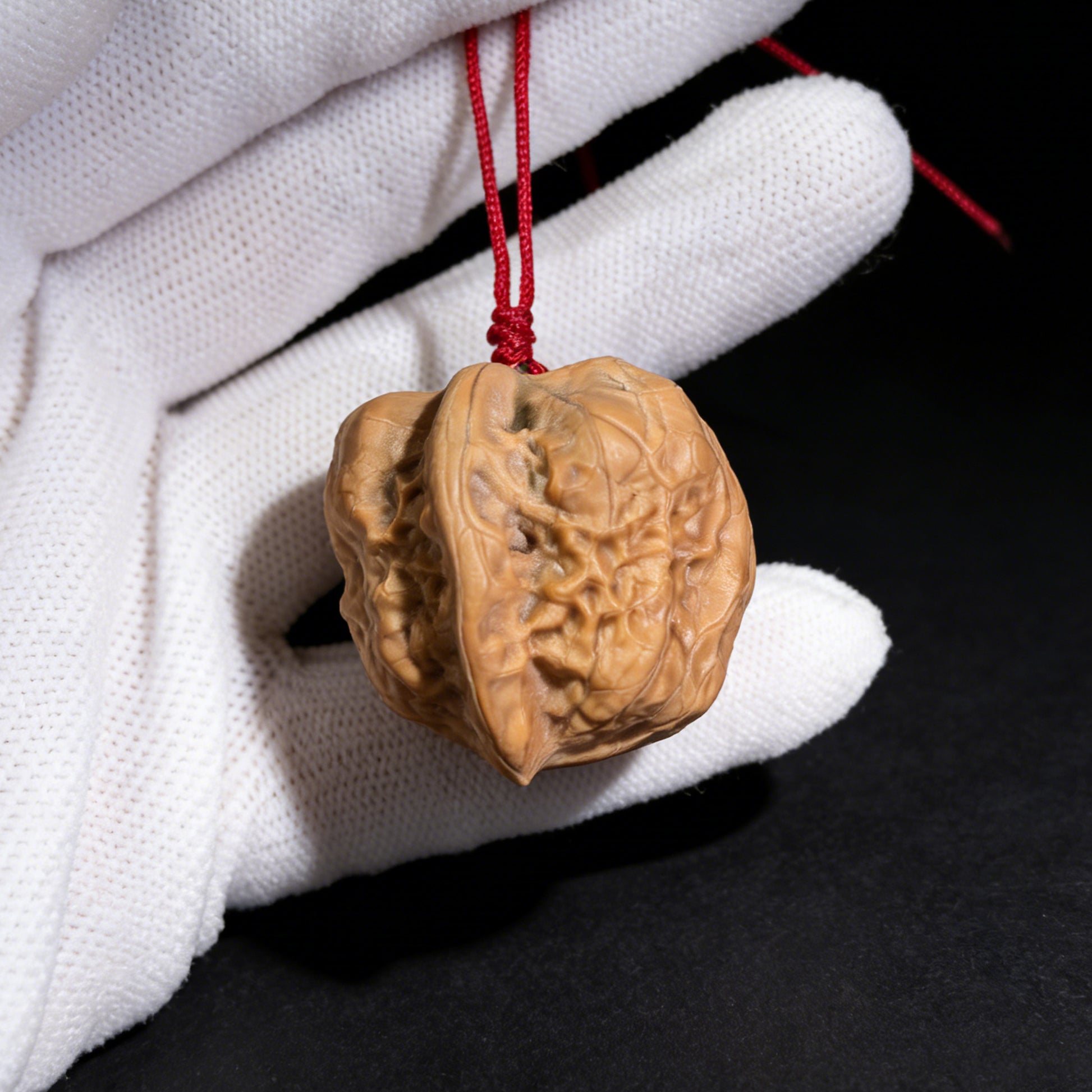 Walnut hand exerciser pendant by ThePatinaProject featuring natural sculptural form and hand-drilled craftsmanship, 32mm accessory.