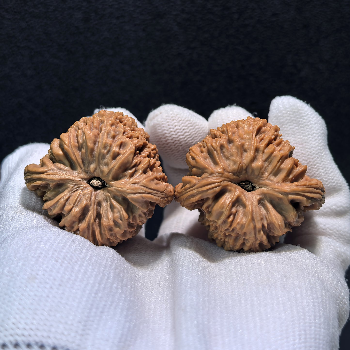 Walnut hand exercisers, Triangle Nan Jiang Shi pair, 39mm x 37mm, from ThePatinaProject, showing textured wooden grips.