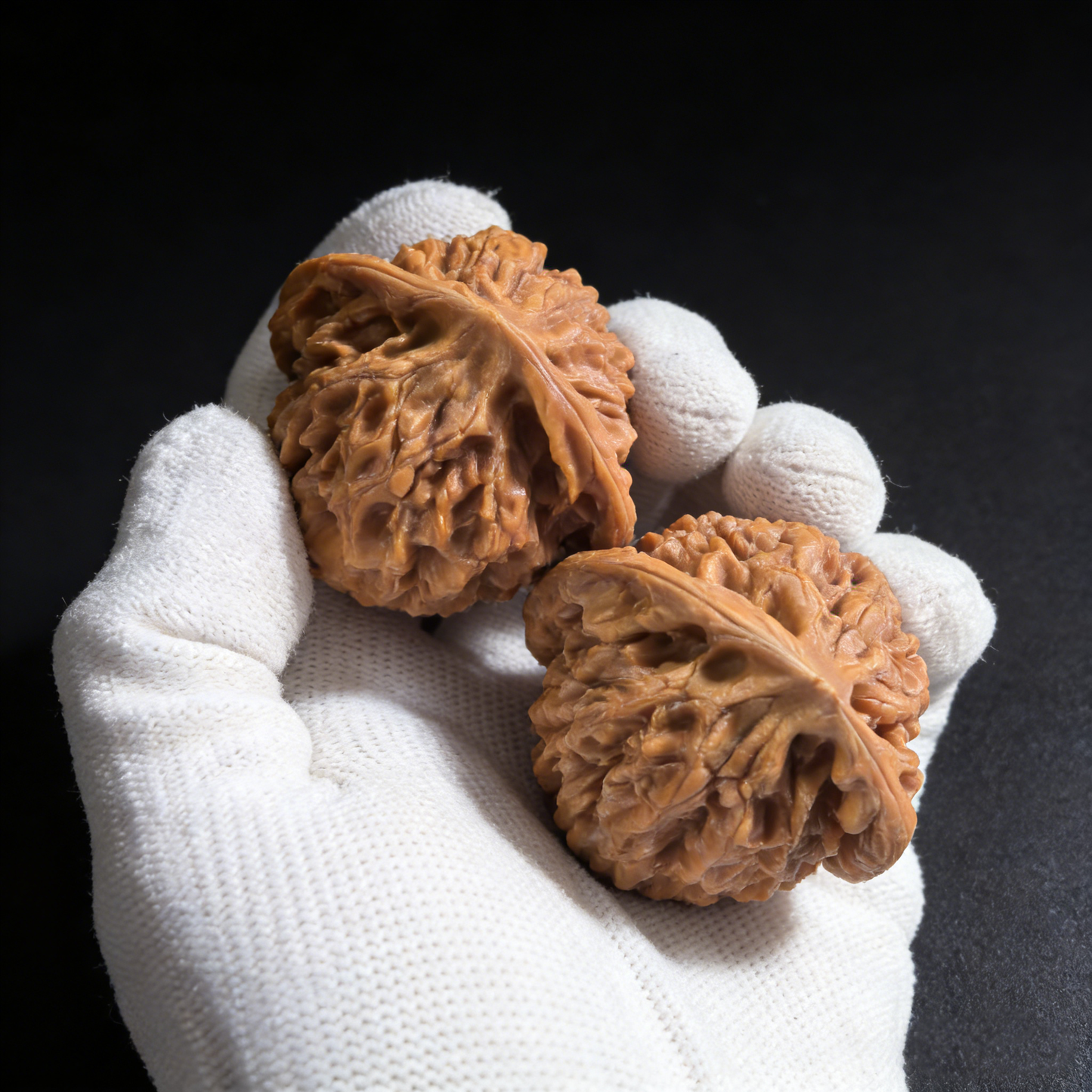 Pair of Wang Yong Da Guan Mao walnut hand exercisers, 47mm, from ThePatinaProject, featuring detailed carved official's hat design.