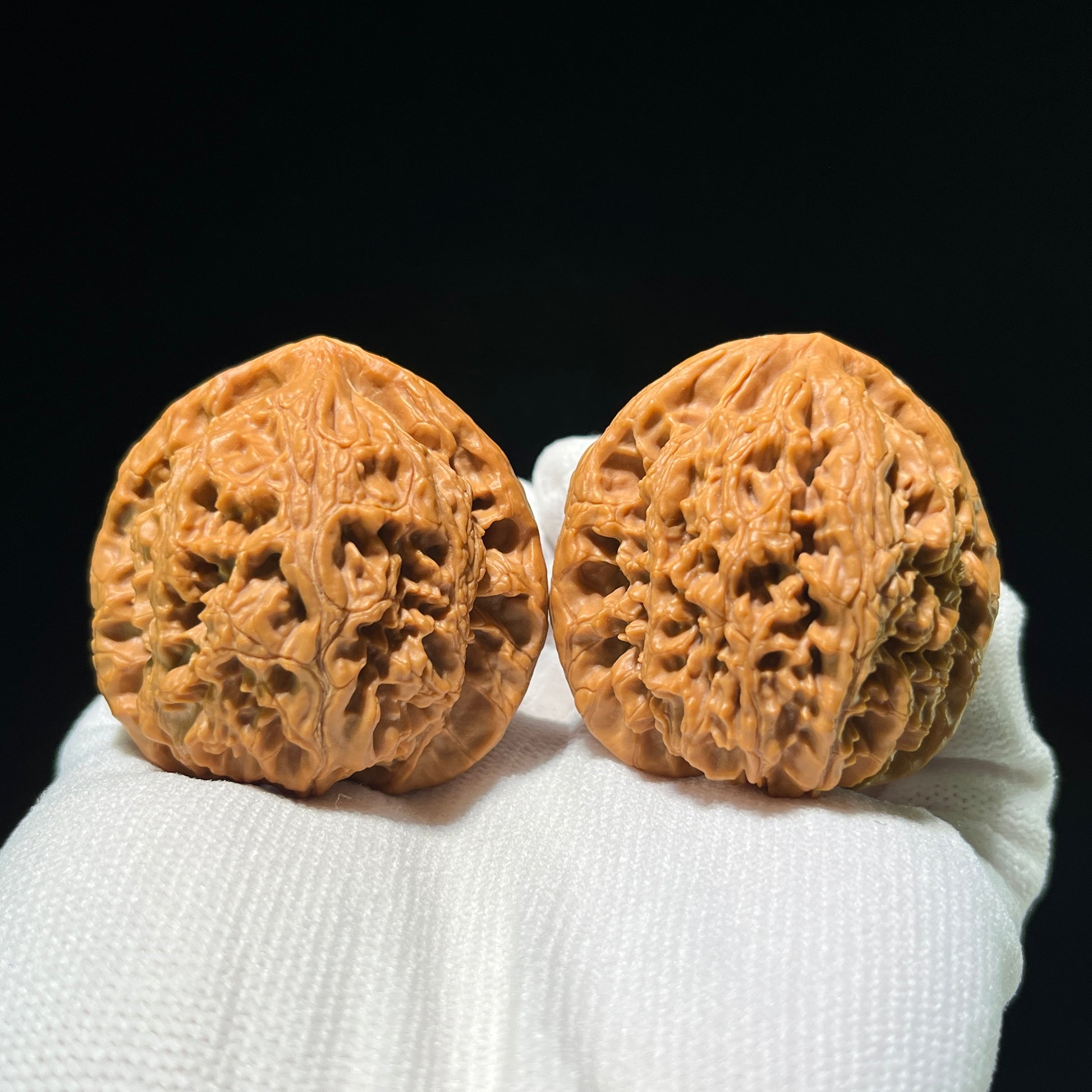 Pair of Walnut Water Dragon hand exercisers by ThePatinaProject, boutique grade, featuring intricate carved dragon designs, 43mm x 42mm.
