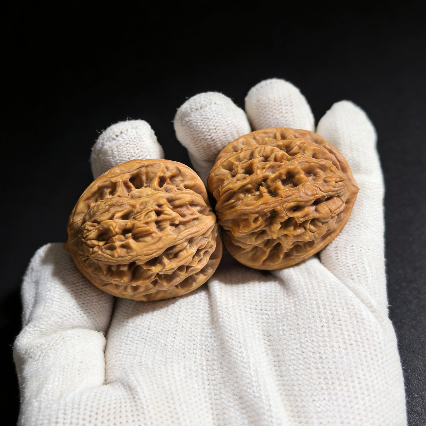 Pair of Walnut hand exercisers with wheat ear tiger head design, 35mm size, from ThePatinaProject.