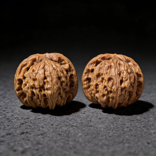 White Lion Bai Shi Zi walnut hand exerciser pair, 37mm x 36mm, from ThePatinaProject, featuring smooth wooden surface with natural grain.