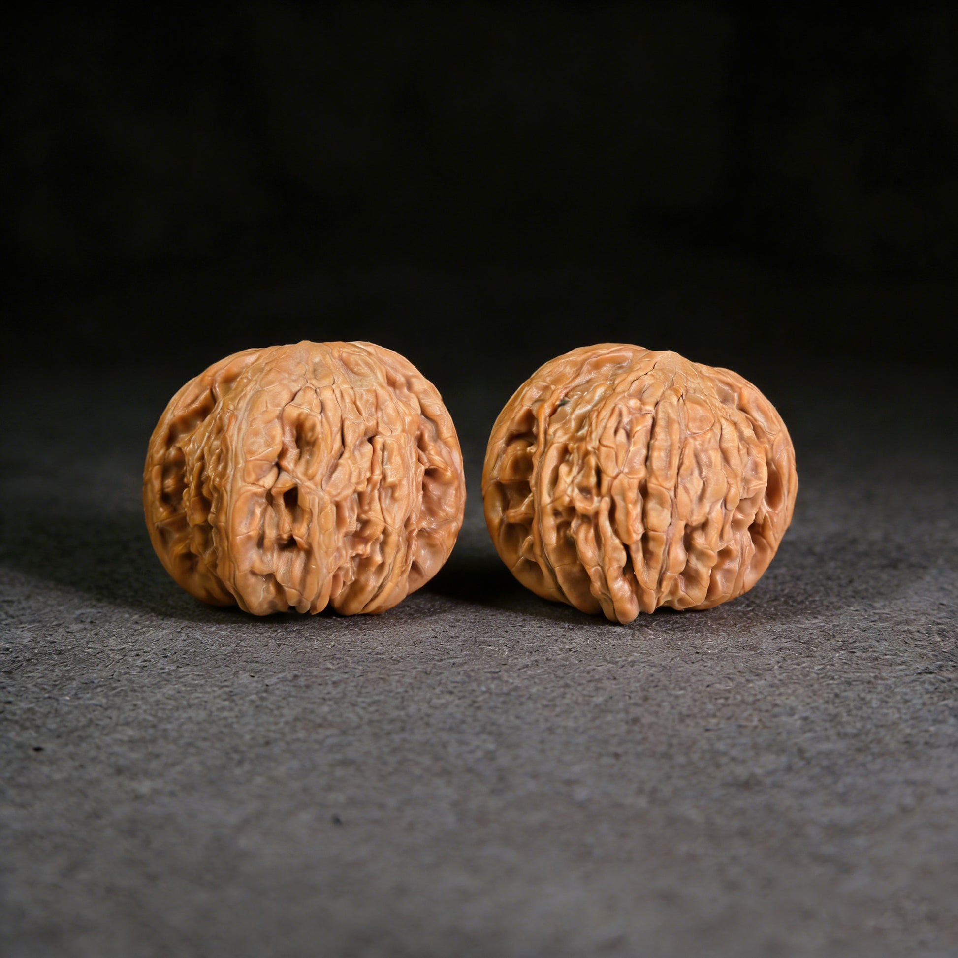 White Lion Walnut Hand Exerciser pair from ThePatinaProject, 39mm x 36mm, showing polished walnut handles and textured grips.